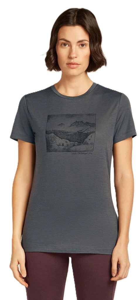 A woman wearing a short sleeve gray t-shirt with a black square graphic.