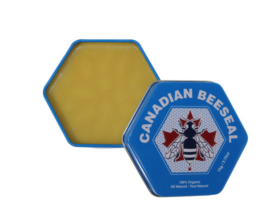 Open hexagon container of yellow beeswax next to a closed blue hexagon container labeled "CANADIAN BEESEAL" with a red maple leaf centered above a bee graphic.