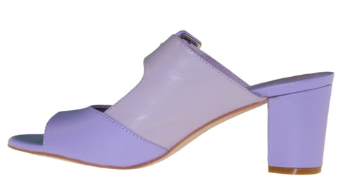 Side view of a lavender heeled mule with an open toe and block heel.
