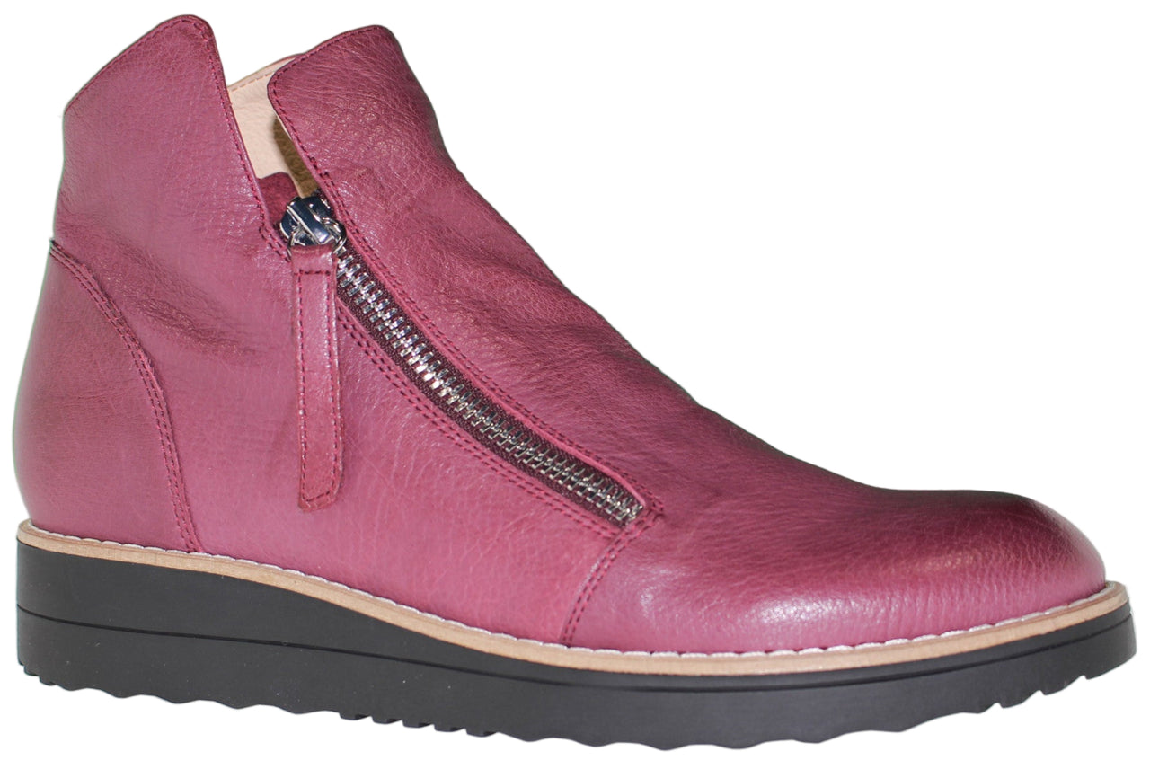 A high top leather shoe with a side zipper and a black platform sole.