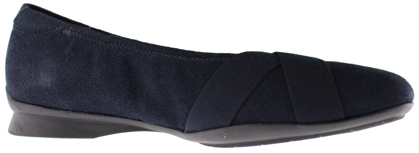 A navy blue ballet flat with crossing elastic straps.