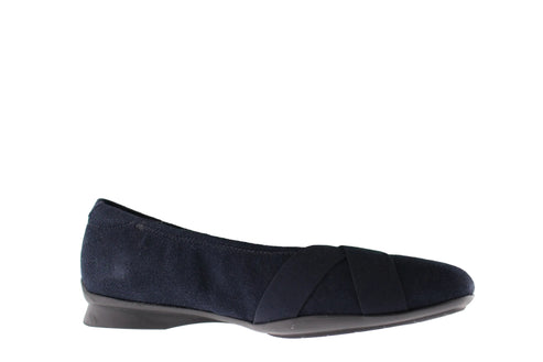 A navy blue ballet flat with crossing elastic straps.