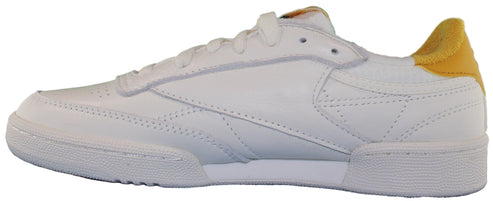A white sneaker with yellow heel.