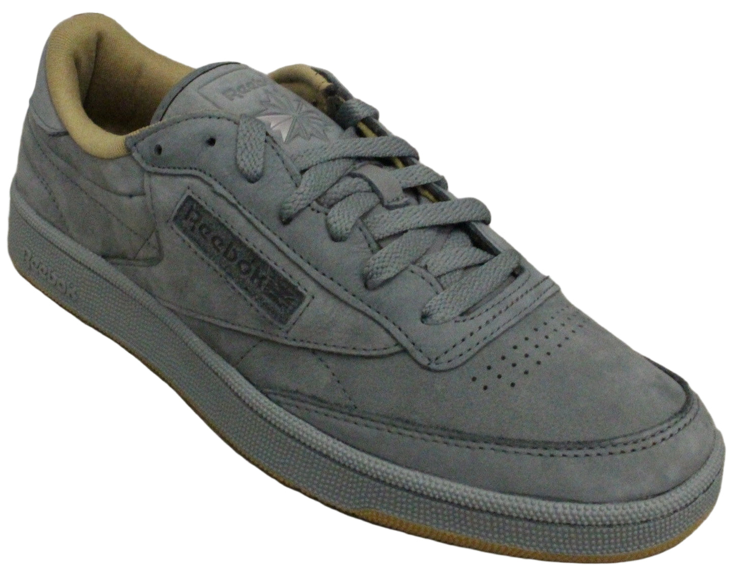 Gray suede sneaker with tan interior and gray laces.