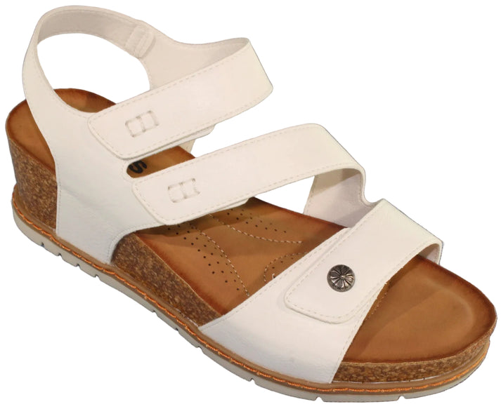 White sandal with adjustable straps and a cork wedge heel.