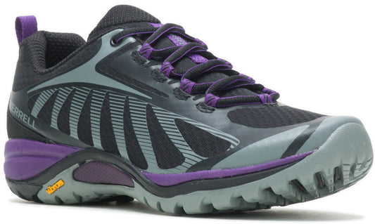 A trail running shoe with a black and gray mesh upper, purple accents on the midsole and laces, and a rugged light gray Vibram outsole with a pull tab at the heel and the text Merrell visible on the side.