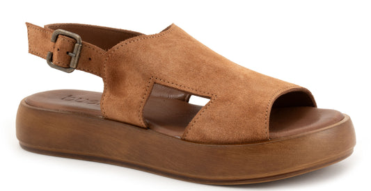 Tan suede sandal with adjustable buckle ankle strap and thick sole.