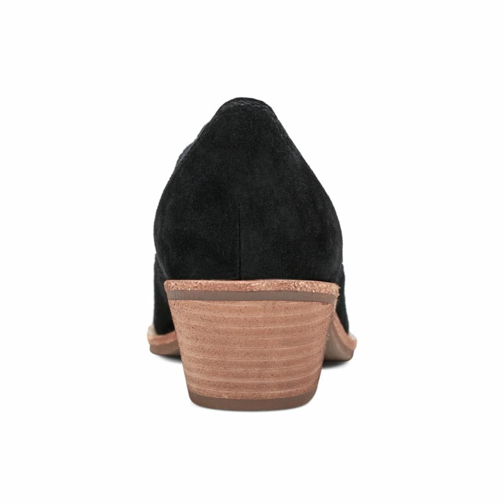 Rear view of a black suede heeled loafer.