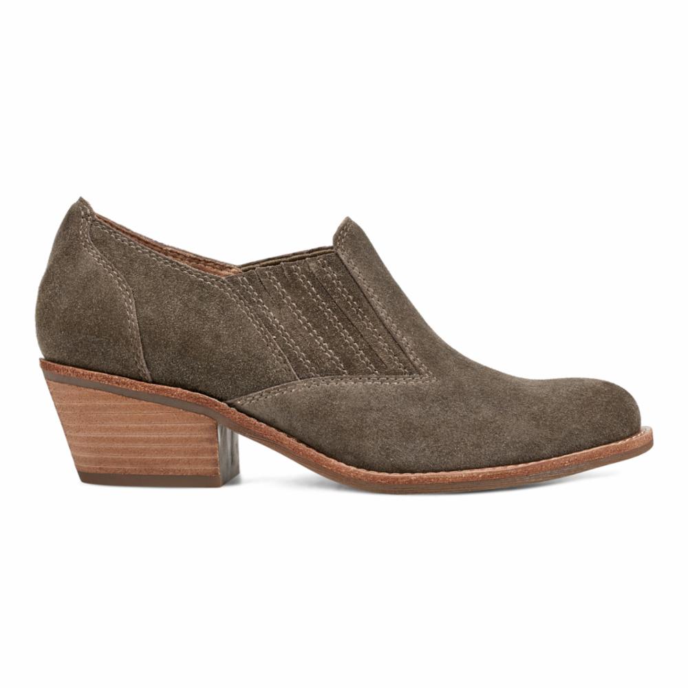 Side view of a suede ankle boot with a low wooden heel in taupe.