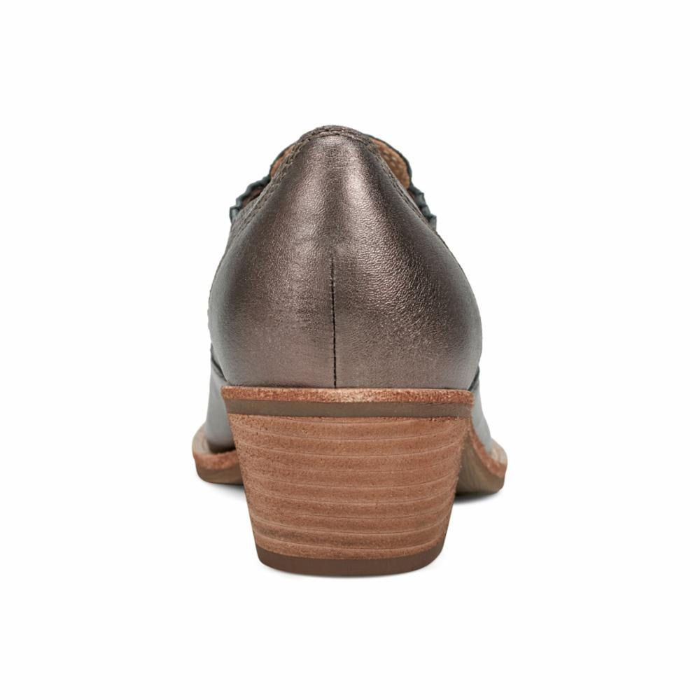 Rear view of a metallic pewter-colored leather shoe with a wood-look stacked heel.