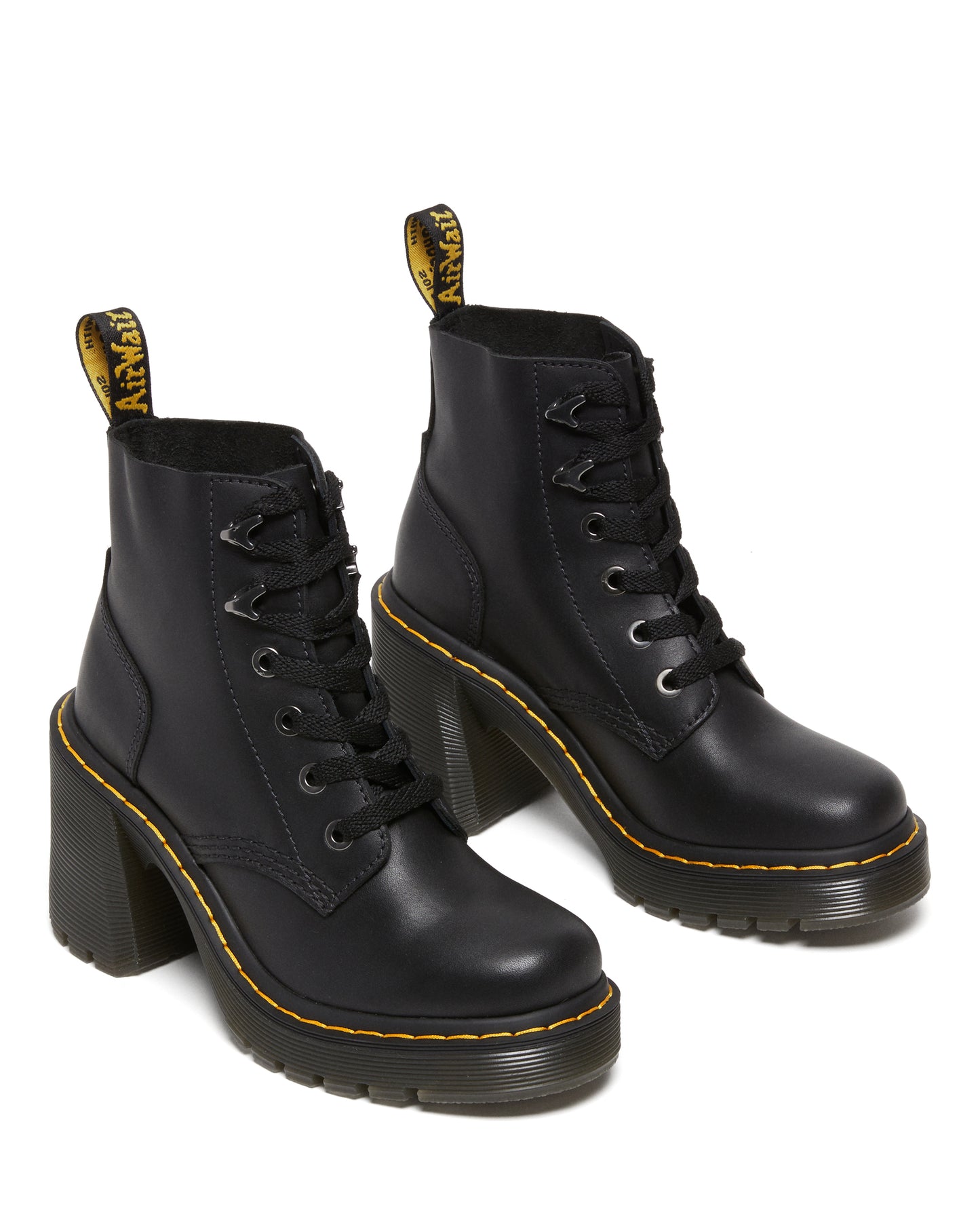 A pair of black leather ankle boots with thick, high heels and yellow accents.