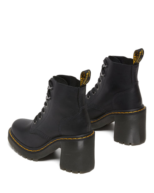 Pair of black leather heeled boots with yellow stitching.