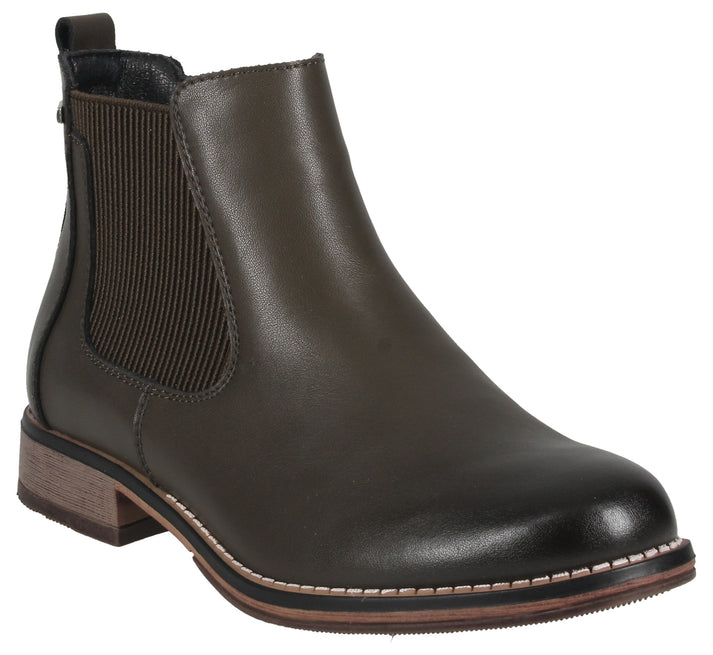 A dark olive green leather Chelsea boot with a round toe, ribbed elastic side panels, a small stacked heel, and a thick brown stitched sole.
