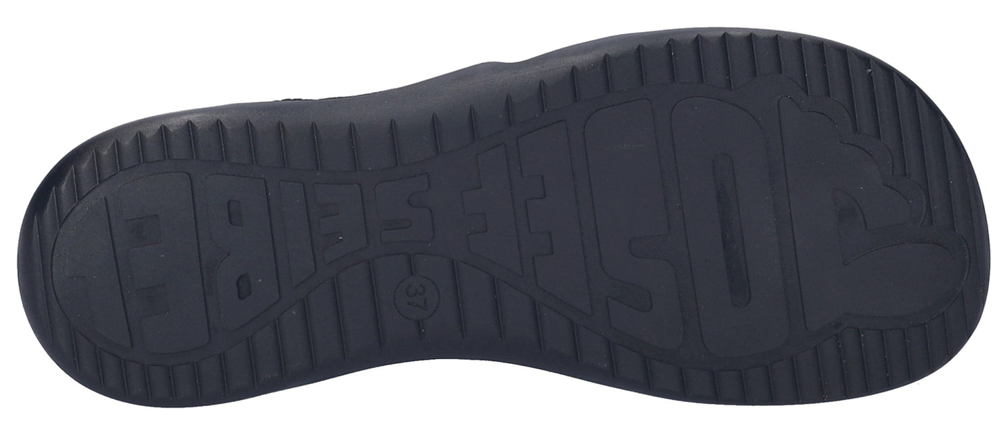 A dark sole of a sandal with gripping texture and some text.