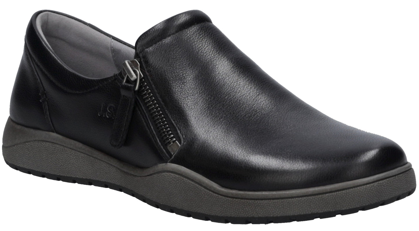 A black leather slip-on shoe with a side zipper and a grey rubber sole against a white background.