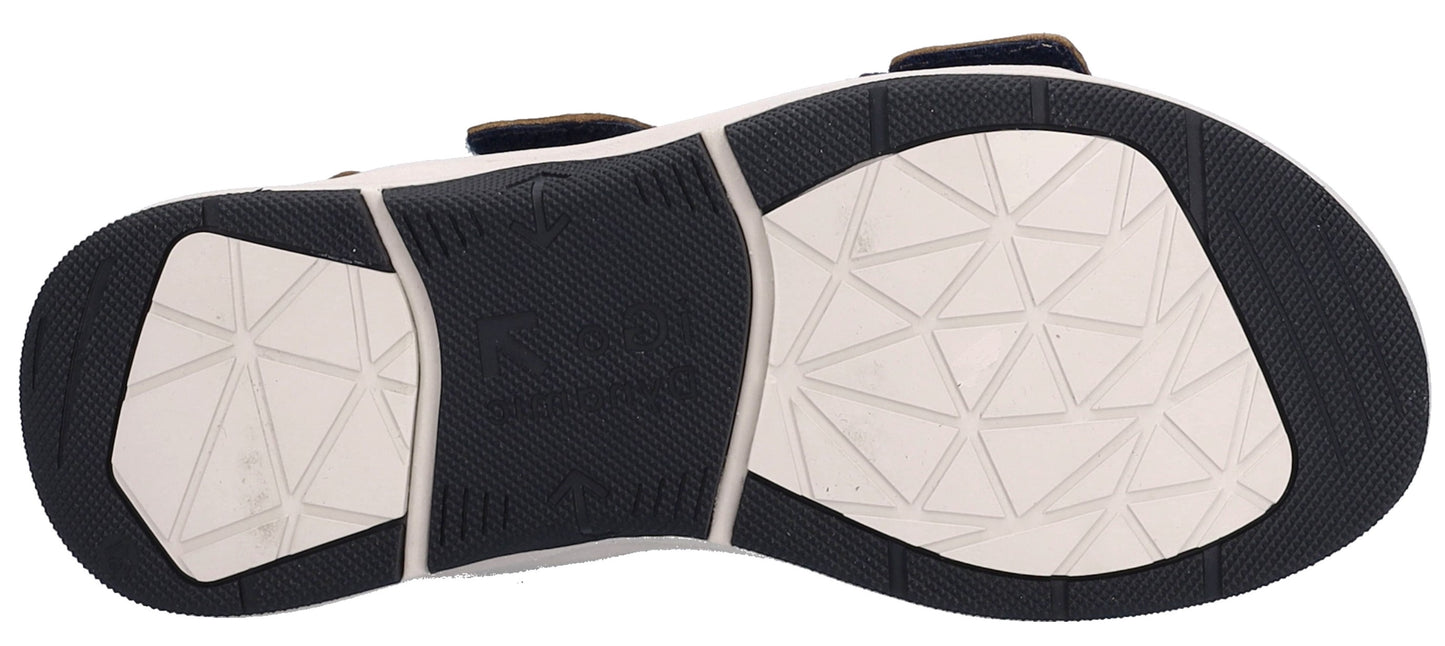 The sole of a sandal, showing a white geometrical pattern surrounded by black.