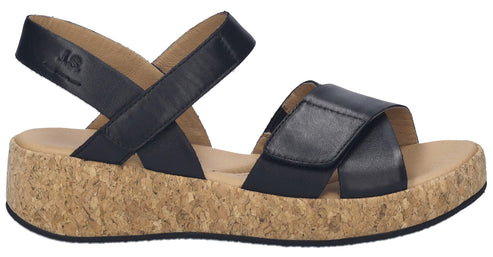 Black sandal with cork sole and velcro straps.