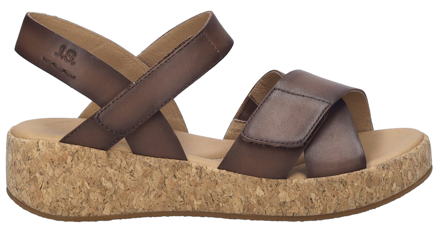 Brown platform sandal with criss-cross straps and velcro closures.