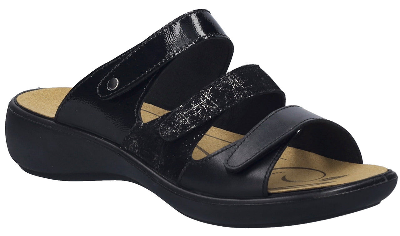 Black sandal with three straps and a wedge heel.