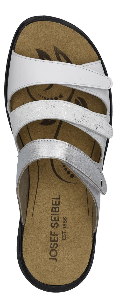 A sandal with 3 straps that are white and silver. The sole has the name JOSEF SEIBEL EST 1886.