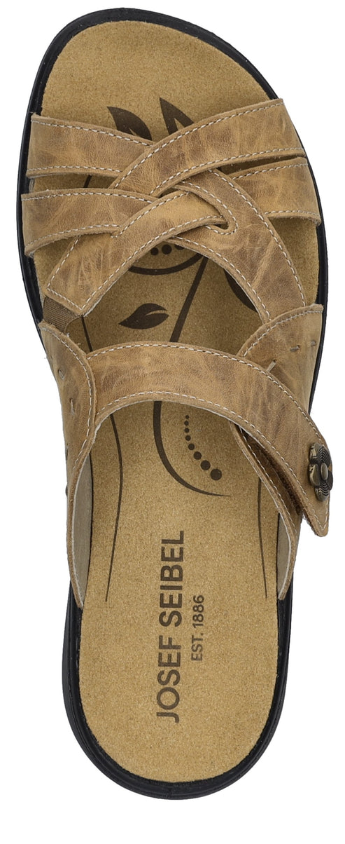 A tan sandal with multiple straps, including a strap that is adjustable with a flower-shaped buckle, and text on the sole that reads "JOSEF SEIBEL EST. 1886".