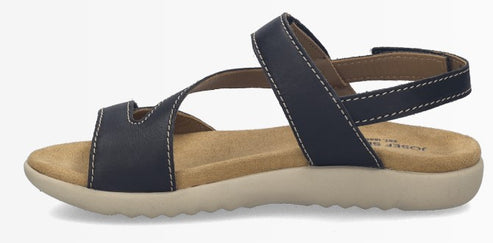 Navy blue leather sandal with tan footbed and white contrast stitching.