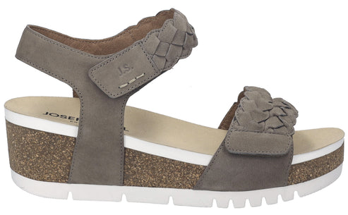 Taupe wedge sandal with braided straps and velcro closure.