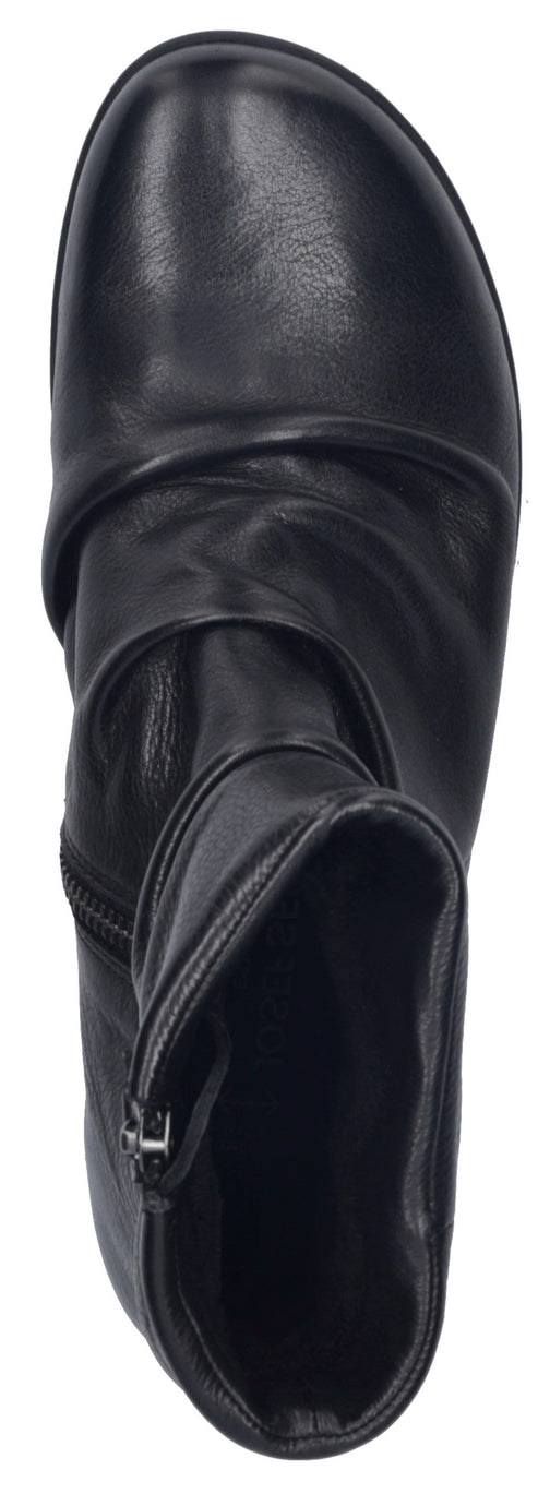 A top-down view of a black ankle boot featuring a rounded toe and ruched leather detailing around the upper, with a side zipper closure visible near the opening.