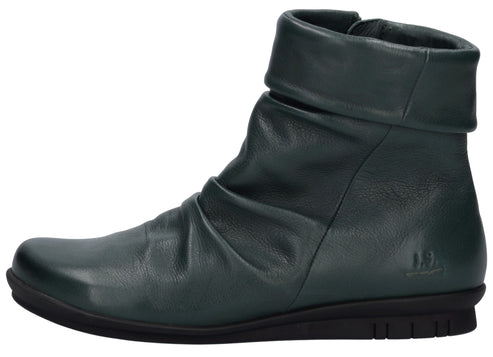 A dark teal, slouchy leather ankle boot with a rounded toe, a folded cuff at the top, and a flat black ridged rubber sole, viewed from the side.