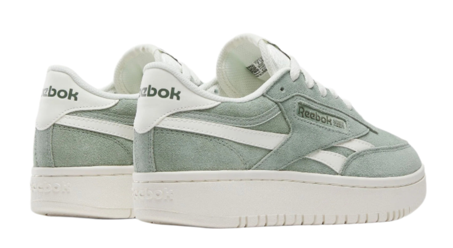Two light-green low-rise platform sneakers with white laces and white lettering on the heel.