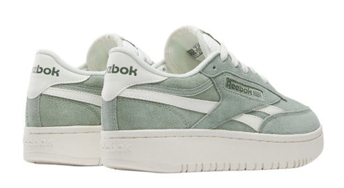 Two light-green low-rise platform sneakers with white laces and white lettering on the heel.