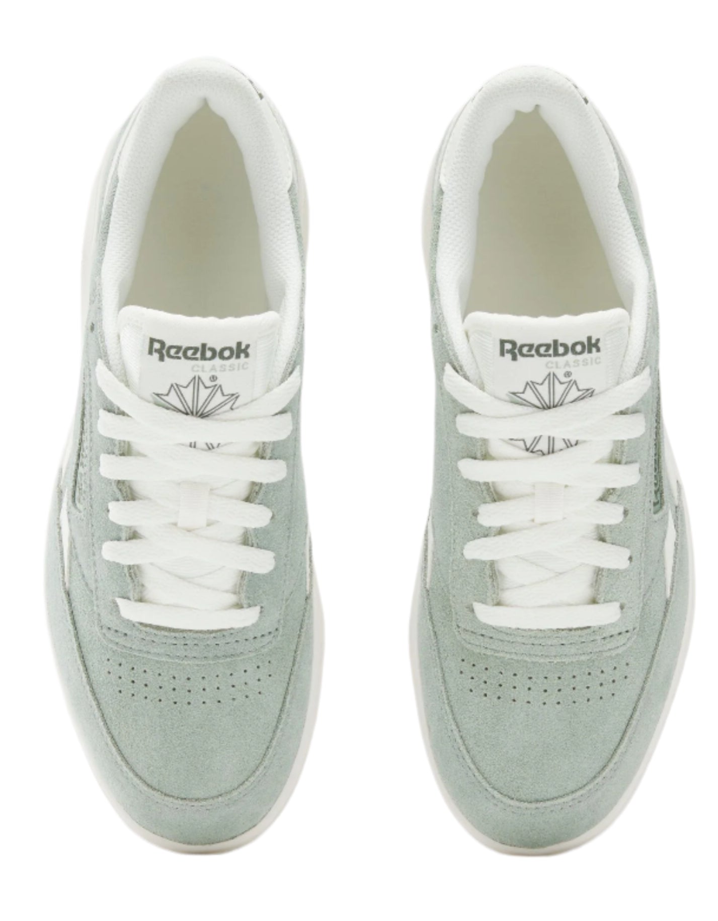 Two mint green suede sneakers with white laces. The sneakers each have the word "Reebok" and a leaf logo on the tongue.