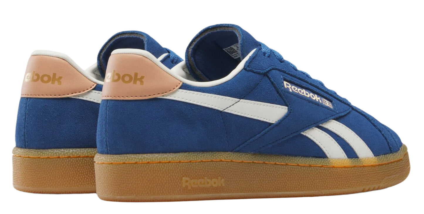 Low top blue and white sneakers with tan sole and heel.