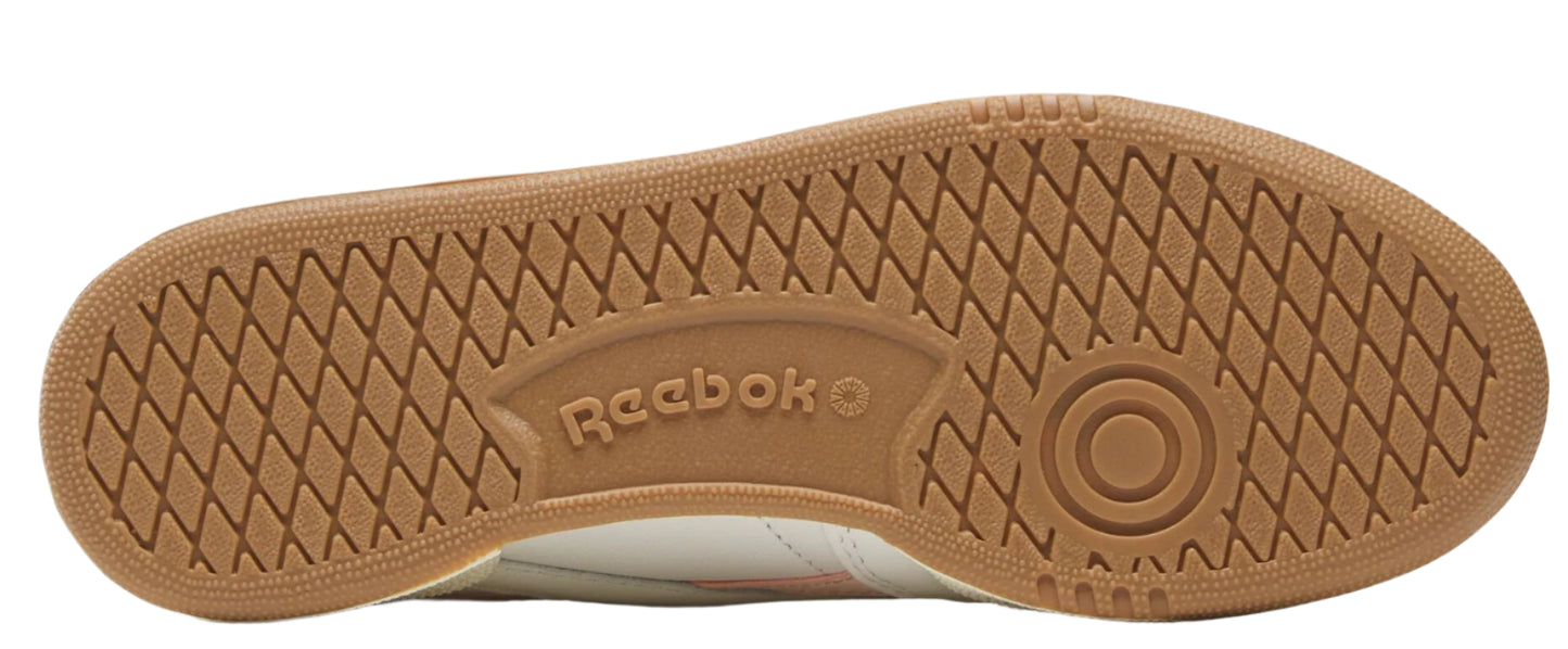 The tan outsole of a sneaker with a diamond pattern.