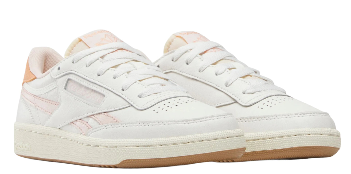 Two low-top white sneakers with pink accents and brown soles.