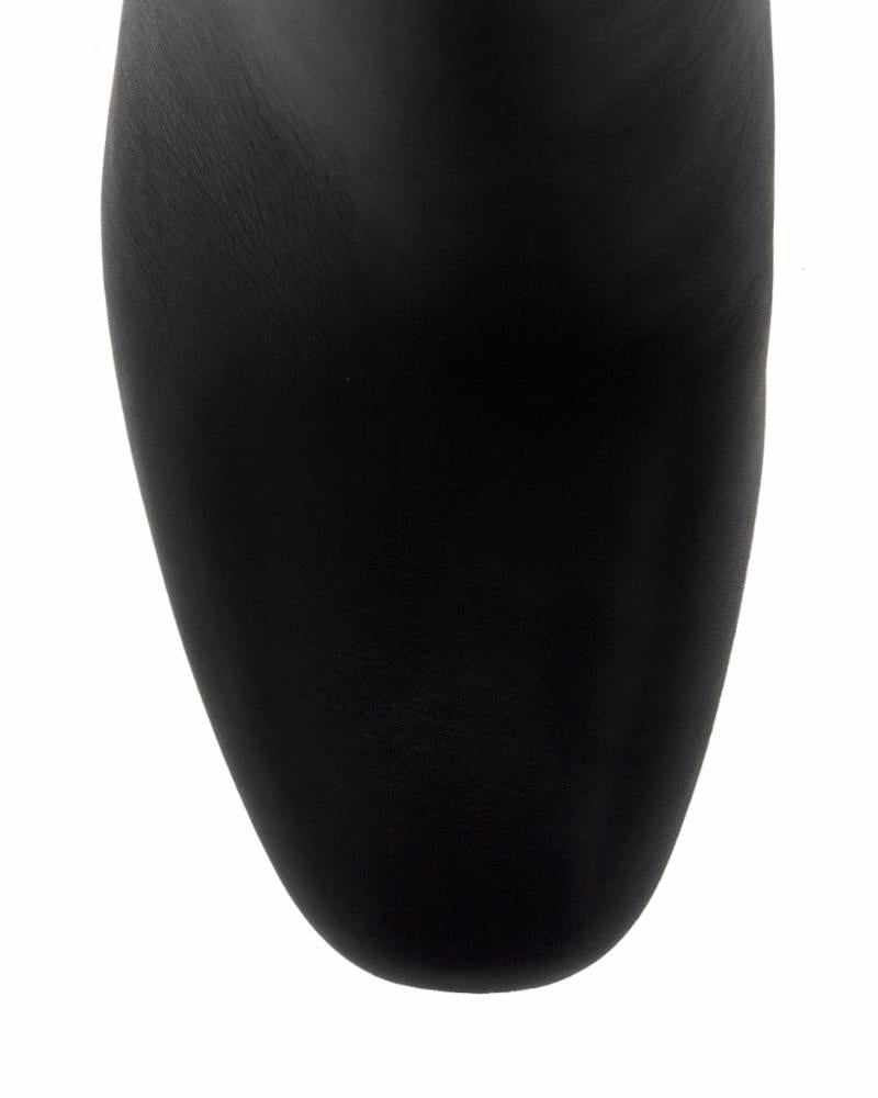 Close-up of a black leather shoe toe.