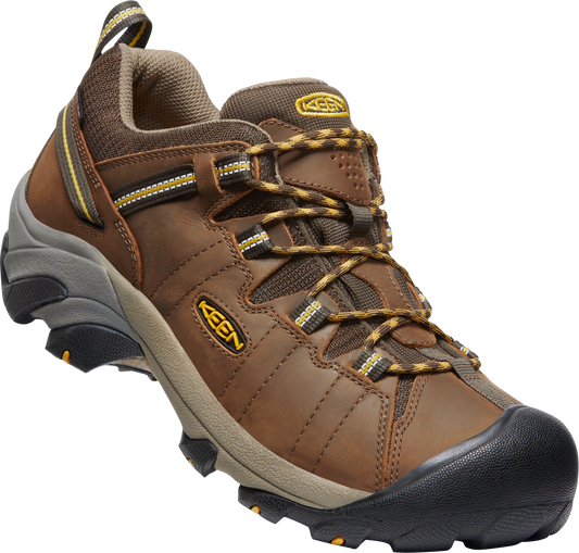 Brown leather hiking shoe with black toe cap and speckled brown and black laces.