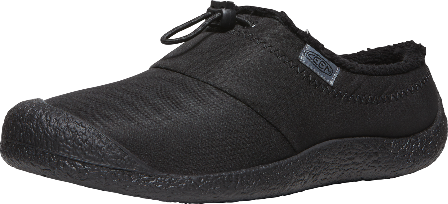 A black slip-on shoe with a rounded toe and a toggle at the top.