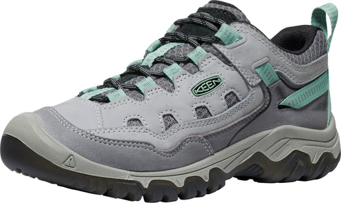 A gray and light teal Keen hiking shoe viewed from a three-quarter angle, featuring a textured mesh and leather upper, a dark gray lugged sole, and a pull tab on the heel.