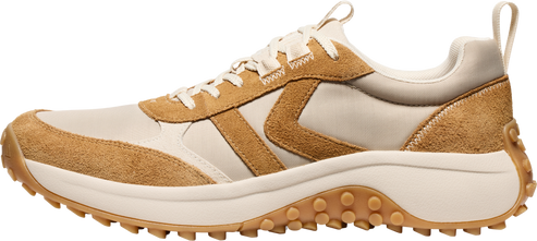 A tan and beige sneaker with a thick, studded sole.