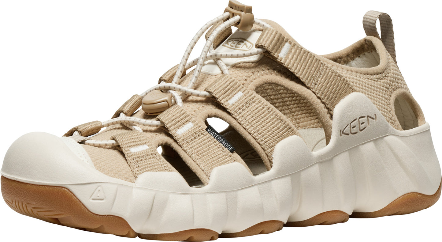 Beige sandal featuring adjustable bungee laces, closed toe, and thick textured sole with the word "KEEN" on the side.