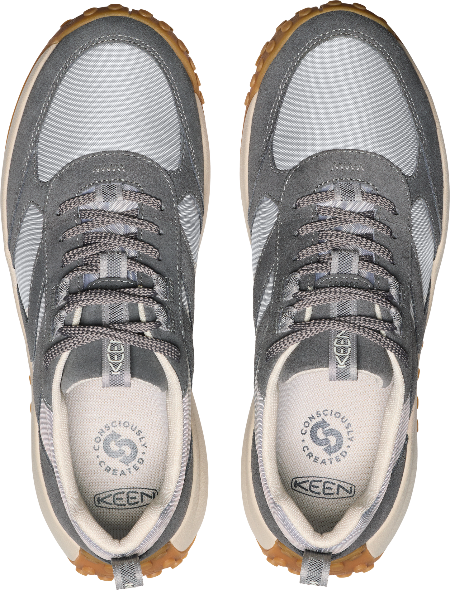 A pair of grey low top sneakers with grey laces and cream insoles.