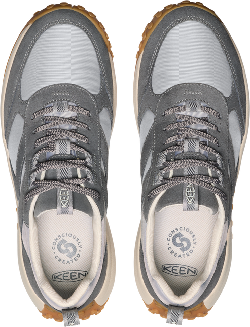 A pair of grey low top sneakers with grey laces and cream insoles.