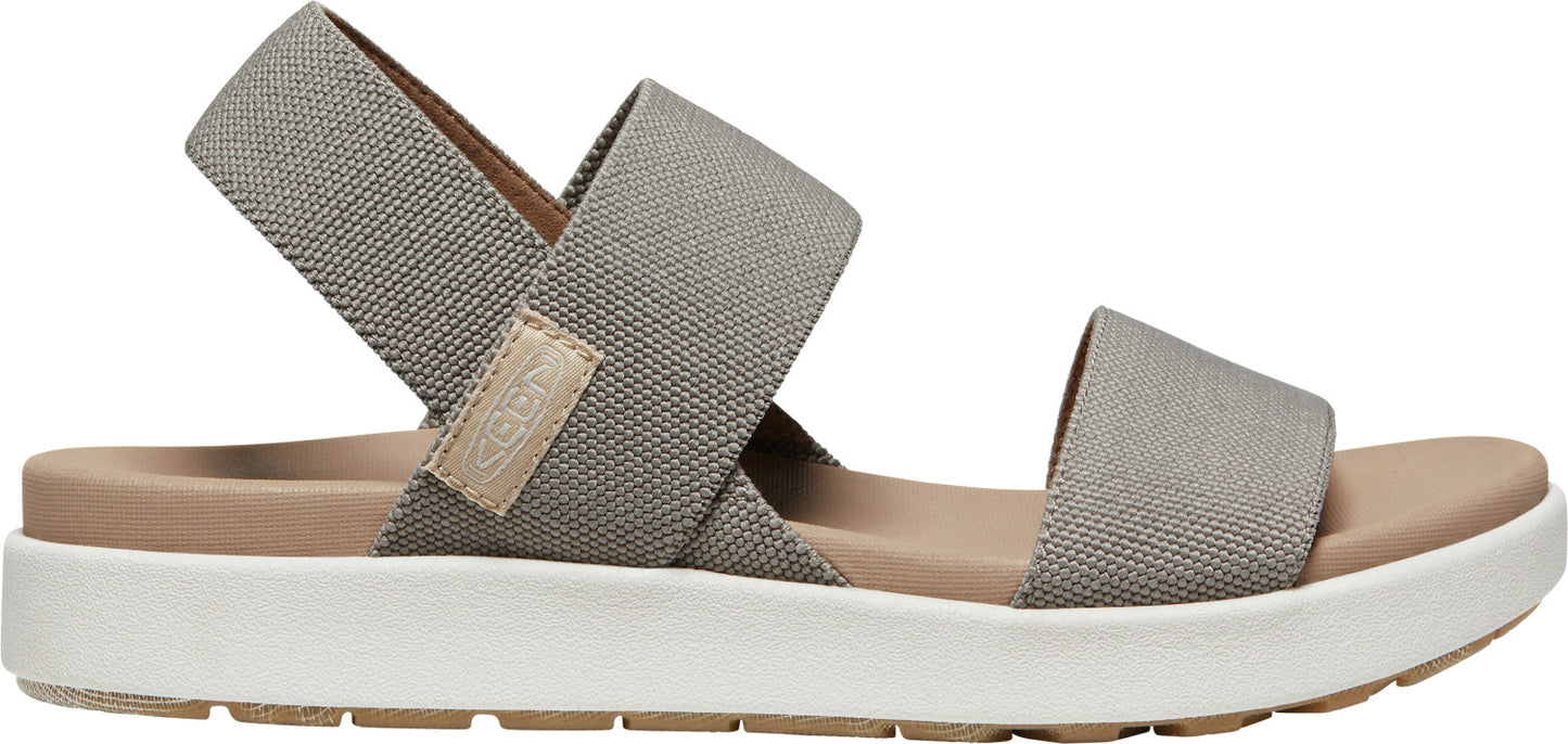 A gray sandal with crossed straps.