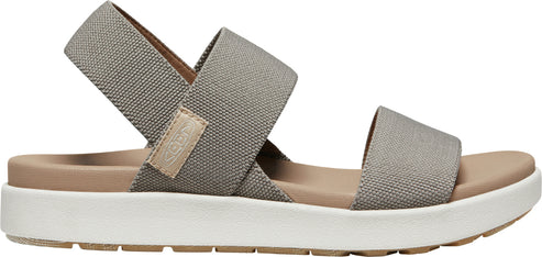 A gray sandal with crossed straps.