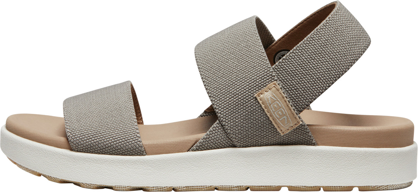 A sandal with crossover canvas straps in gray.