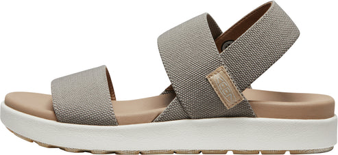 A sandal with crossover canvas straps in gray.