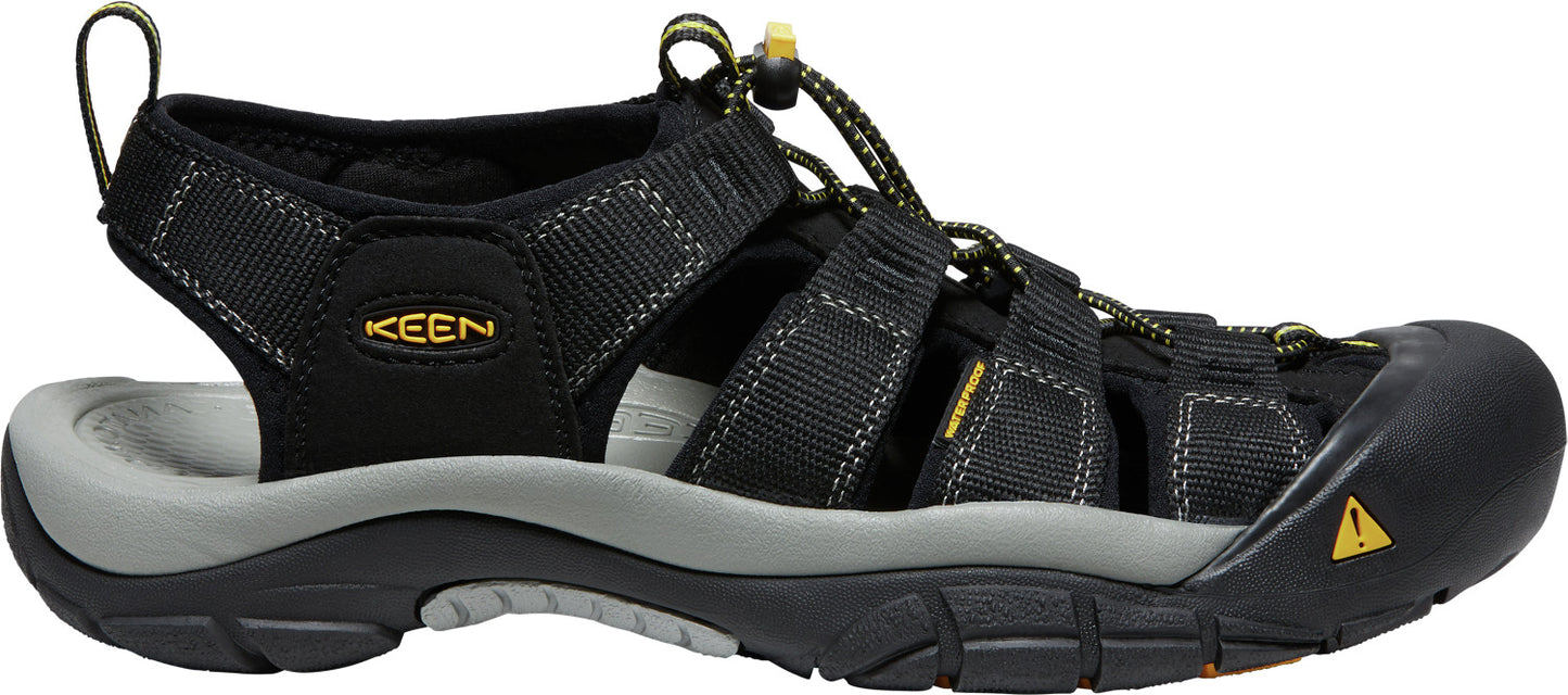 A black and grey sandal with a toe cap and adjustable straps.