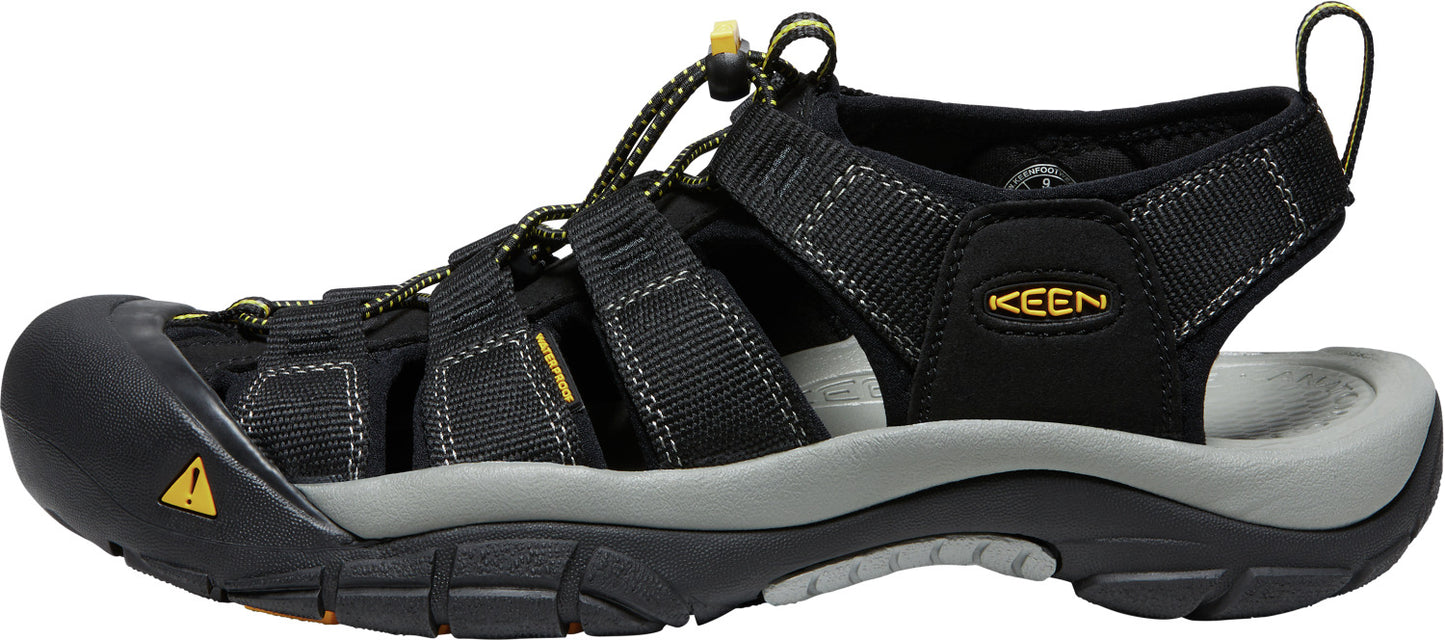 A black sandal with multiple straps and the text 'KEEN' visible.