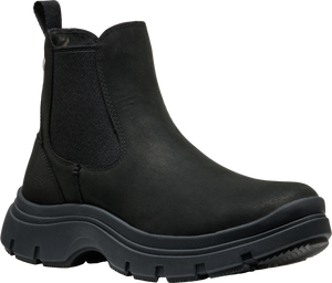 A black Chelsea-style boot with a thick, lugged sole and elastic side panels.